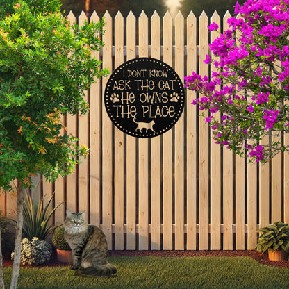 Circular Metal Sign that reads "I Don't know Ask the Cat, He Owns the Place"